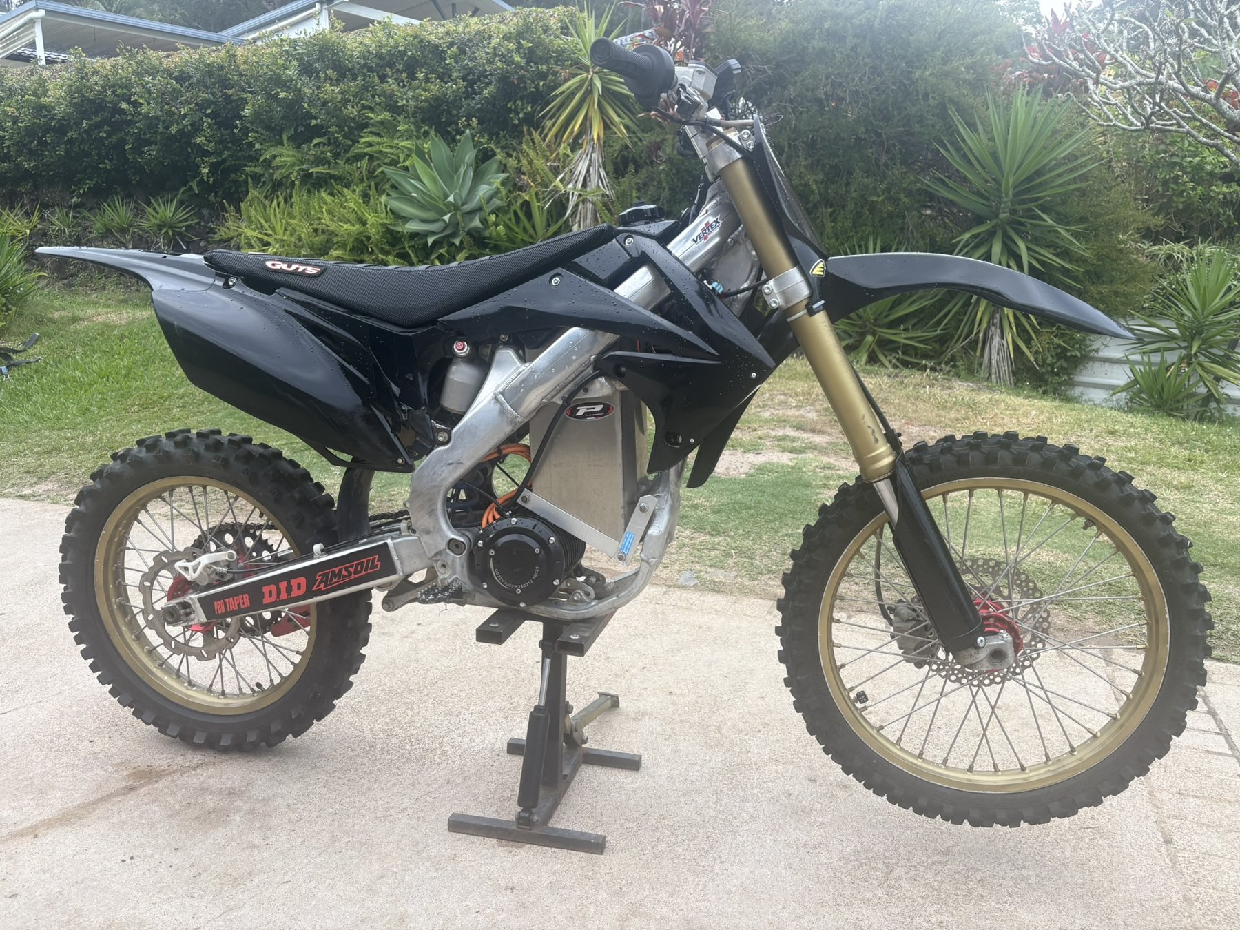 Black electric conversion on a petrol MX frame with gold forks and rims