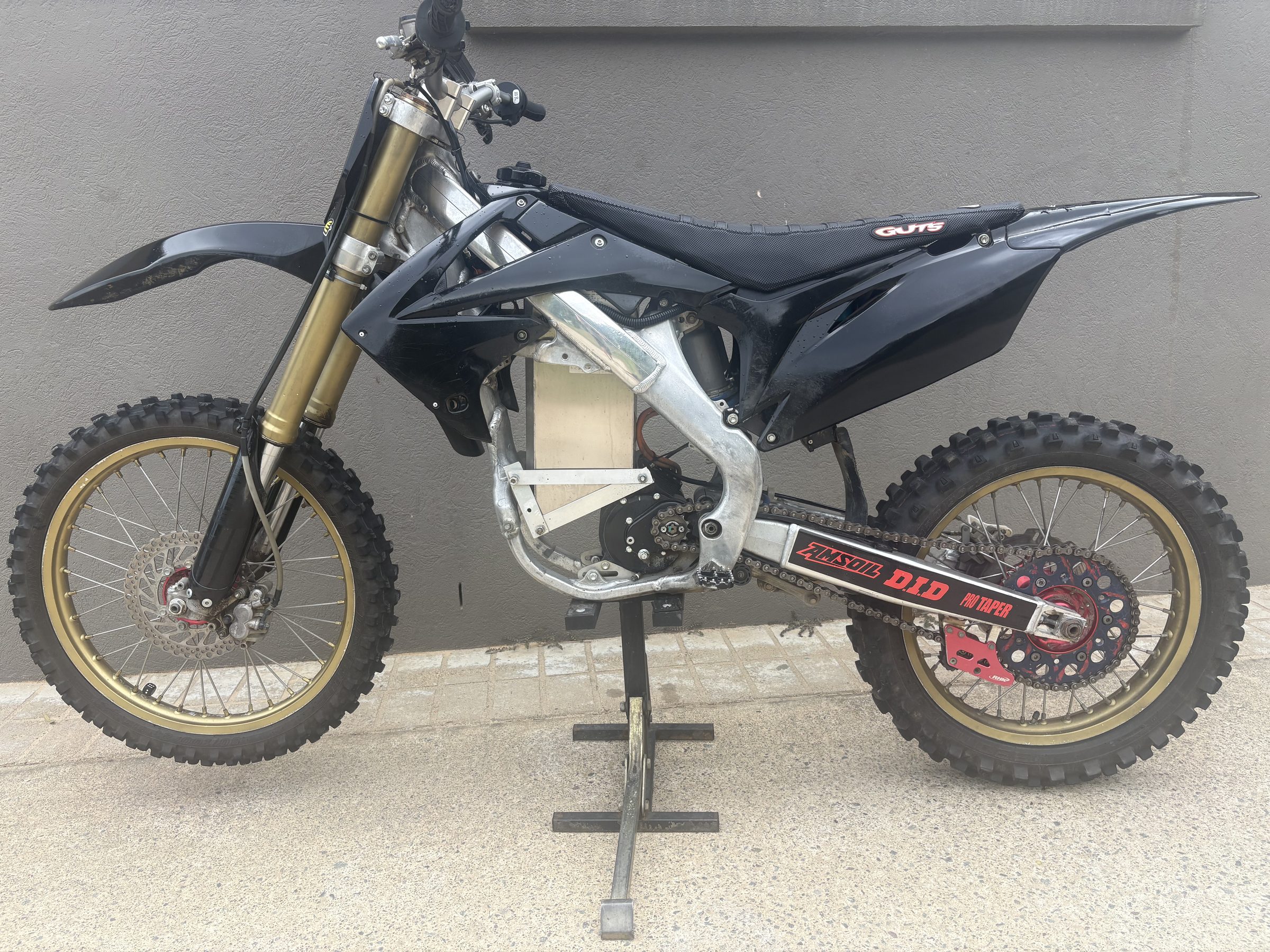 Black and gold electric dirt bike conversion built by Fast E